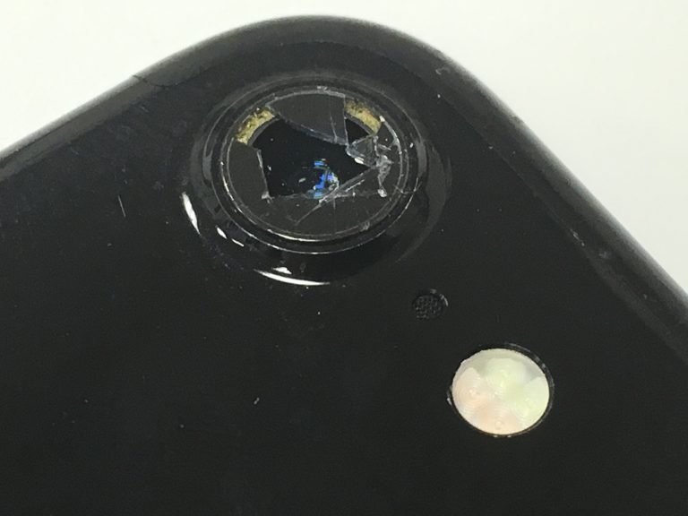 外カメラのレンズにヒビが広がっていて穴が開いているiPhone