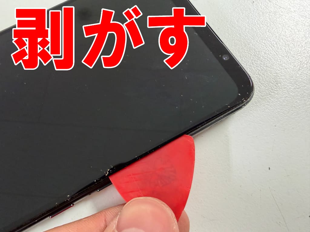 故障した画面パーツを本体フレームから剥がしているROG Phone7