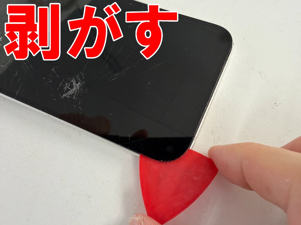 画面と本体フレームとの粘着を剥がしているiPhone14Plus