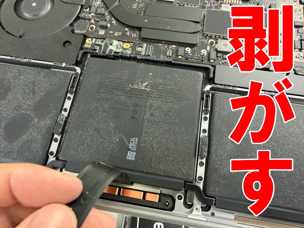 バッテリー上からケーブルを剥がしたバッテリー交換中のMacBook Pro(A2338)